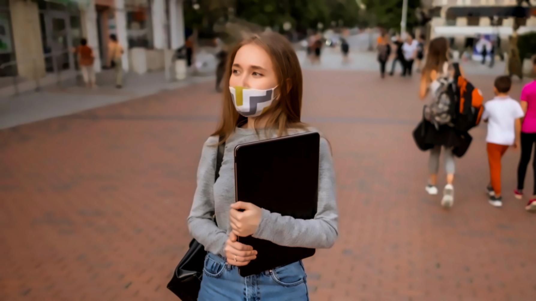 Close-up view of hands working with budget planning documents, calculator, and mobile banking apps on a wooden desk
